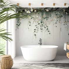 a white bath tub sitting next to a tall plant in a room with large windows