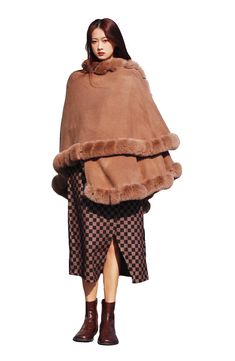 Add a toasty yet glam finish to your elegant ensemble with this draped cape that is trimmed with faux fur. Open front Short sleeves Shell/faux fur: 100% polyester
 Hand wash, line dry Imported Winter Cape-shaped Faux Fur Coat, Faux Fur Winter Cape Coat, Elegant Faux Fur Cape With Lining, Elegant Cape-style Fur Coat With Faux Fur Lining, Elegant Cape With Faux Fur Lining, Winter Faux Fur Cape Coat, Elegant Cape With Faux Fur, Elegant Faux Fur Cape Outerwear, Elegant Faux Fur Winter Cape