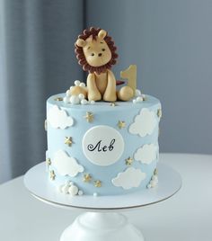 a blue and white cake with a lion on top