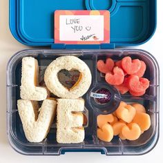 a bento box filled with lots of food and the word love spelled out in it