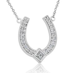 Introducing the Designer Diamond Horseshoe Pendant, a stunning symbol of good luck and elegance. Crafted from 14K white gold, this horseshoe pendant measures 16mm tall (6/10 inch) and 13mm wide (5/10 inch), making it a beautiful and eye-catching accessory. The pendant comes with a 14K white gold chain, available in either a 16 or 18-inch length, adding to its versatility and wearability. Adorned with round-cut diamonds and one princess-cut diamond, the pendant sparkles with a total diamond weigh Luxury Horseshoe-shaped Formal Jewelry, Luxury Horseshoe Jewelry For Formal Occasions, Classic Horseshoe Jewelry, White Gold Horseshoe Jewelry For Anniversary, Elegant Horseshoe Jewelry For Anniversary, Elegant Silver Horseshoe Necklace, Formal Horseshoe Jewelry With Diamond Accents, Formal Horseshoe Diamond Jewelry, Elegant Sterling Silver Horseshoe Jewelry