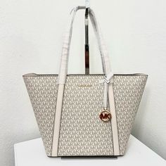 100% Michael Kors Authentic Guarantee And Firm Price ! Details Tote Bag Logo-Print Canvas 88.3% Coated Canvas/9.2% Polyester/1.9% Cotton/0.6% Polyurethane Trim: 60% Polyurethane/20% Cotton/20% Polyester Gold-Tone Hardware 18”W X 12”H X 5”D Handle Drop: 11” Interior Details: Back Slip Pocket Zip Fastening Dust Bag Not Included Imported Beige Double Handle Bag With Logo, Cream Tote Shoulder Bag With Logo, Cream Logo Tote Shoulder Bag, Beige Shoulder Bag With Logo For Shopping, Beige Logo Shoulder Bag For Shopping, Designer White Coated Canvas Bags, Luxury Cream Bags With Logo, Cream Shopping Bag With Logo, Cream Bags With Logo For Shopping