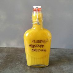 a yellow glass bottle with writing on it