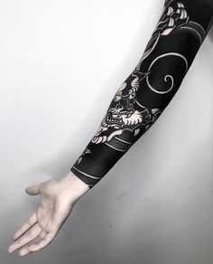 a person with a black and white tattoo on their arm