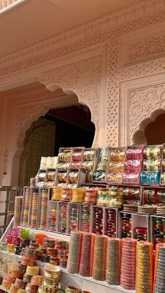 many different types of food on display in front of a building with arches and doorways