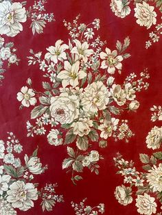 a red background with white flowers and green leaves