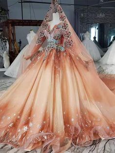 an orange and white wedding dress on display