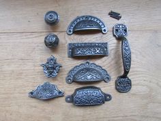 an assortment of metal objects sitting on top of a wooden table