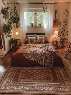 a bed sitting in the middle of a bedroom next to a window with plants on it