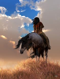 a native american woman riding on the back of a brown and white horse under a cloudy blue sky