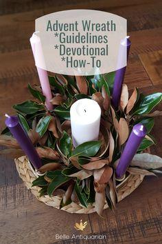 a basket filled with purple candles sitting on top of a wooden table next to a sign