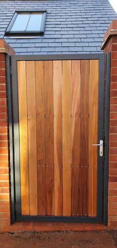 a wooden door is open on the side of a brick building with a solar paneled window