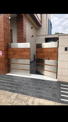 a modern house with wood and metal gates