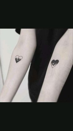 two people with matching tattoos on their arms