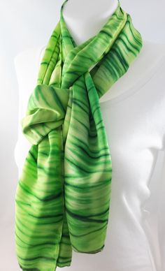 Hand painted silk scarf. Colours used - different shades of green. Design - dyed using the Japanese shibori technique of pole wrapping. Dimensions approx 35cm x180cm / 14 x 72 inches (the steam setting process may cause a little shrinkage). 100% silk satin, a little heavier than my other smooth scarves (weight 12 momme - medium). All edges are hand finished. I have used silk dyes (not paints) as these bond with the fibre of the silk after steam setting, to ensure colour permanence,  more intense Artistic Hand-dyed Green Scarves, Artistic Hand Dyed Green Silk Scarf, Artistic Hand Painted Green Silk Scarf, Hand Painted Green Silk Scarf, Silk Painting Techniques, Japanese Shibori, Shibori Techniques, Silk Scarf Painting, Different Shades Of Green