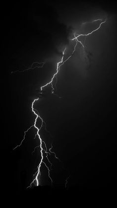 a black and white photo of lightning in the sky