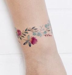 a woman's foot with a flower tattoo on it