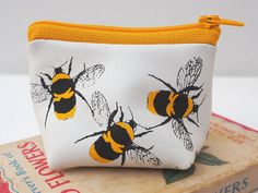 This is a really cute little coin purse in soft white leather screen printed all over with black and yellow bumble bees. This coin purse is really petite, but due to its three dimensional shape you can squeeze all sorts of goodies in - coins, notes, lipstick. It's ideal for protecting precious items from scratches.  It would make a great gift for a mum who wants to organise their bag. The distinctive design makes it really easy to spot in a full handbag.  Gift wrap is available in a black envelo Charger Pouch, Leather Makeup Bag, Black Envelopes, Small Coin Purse, Bumble Bees, Leather Decor, Bee Gifts, Leather Cuts, Bee Print