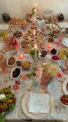 a table is set with plates, cups, and desserts for an elegant dinner