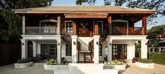 a large white house with wooden balconies