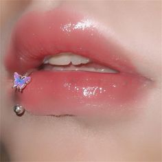 a woman's lips with pink and white glitters on the tip of her lip