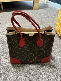 This beautiful Louis Vuitton Flandrin shoulder bag is the perfect addition to any fashionable woman's collection. The red canvas exterior is adorned with the iconic monogram pattern, and the bag is made in France. With its spacious interior and comfortable shoulder strap, this bag is both practical and stylish. This exquisite bag was used only once and has been meticulously cared for, stored in its dust bag and original box when not in use. It retains its original tags, ensuring authenticity and preserving its pristine status. The Flandrin model is a classic, and this bag is sure to turn heads wherever you go. Whether you're running errands or out for a night on the town, this bag is the perfect accessory to complete any outfit. Don’t miss the chance to own this almost-new Louis Vuitton tr Red Rectangular Monogram Canvas Bag, Red Bags With Gold-tone Hardware And Monogram Canvas, Louis Vuitton Red Bag, Louis Vuitton Orange Bag, Louis Vuitton Flower Mm Monogram Canvas & Cowhide Leather Zipped Tote Noir, Red Canvas, Monogram Pattern, Monogram Canvas, Canvas Tote