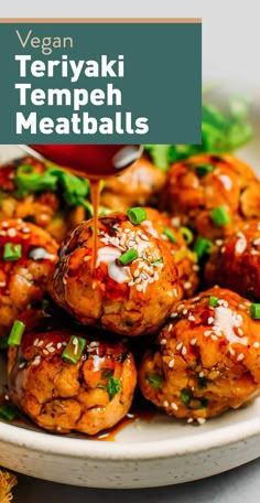 vegan teriyaki tempeh meatballs on a plate with sauce drizzled over them