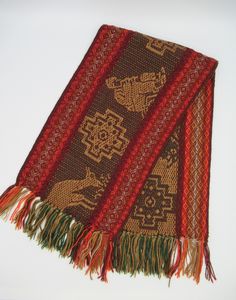 This beautiful Alpaca wool scarf is woven from Alpaca wool blend with llama and chakanas design. This scarf is originally made from local makers in Cusco - Peru. This beautiful scarf is a perfect cozy gift for your love one. Features: * Made from Alpaca and acrylic yarn. Measurements: 62 inches (L) x 9.5 inches (W) Dry clean or hand wash gently in cold water with mild detergent - dry flat - no machine dryer Traditional Winter Scarves With Patterns, Brown Traditional Patterned Scarves, Bohemian Alpaca Scarves For Winter, Traditional Woven Winter Shawl, Traditional Brown Shawl With Woven Motifs, One Size Handwoven Alpaca Shawl, Brown Alpaca Shawl, Bohemian Brown Handwoven Scarves, Bohemian Brown Handwoven Scarf