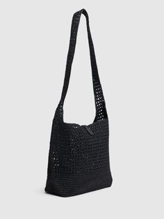 black crocheted bag on grey background