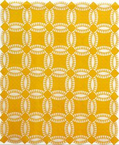 a yellow and white quilt with circles on the front, in an abstract manner that is very similar to traditional american quilts