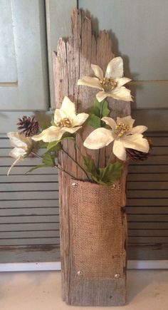 a vase with flowers in it sitting on a table next to a wall and door