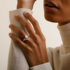 a woman wearing a diamond ring on her finger