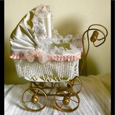 a doll's pram is sitting on a bed