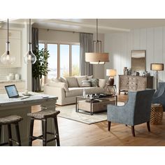 a living room filled with furniture and a laptop computer sitting on top of a table