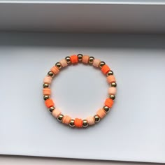 This is an orange beaded bracelet. It is made with clay beads and round beads. It's stretchy so it can fit every wrist. Preppy Fall Bracelet Ideas, Clay Bead Fall Bracelets, Adjustable Orange Beaded Bracelets For Everyday, Orange Round Beads Jewelry For Everyday, Everyday Orange Round Bead Jewelry, Adjustable Orange Bracelets With 8mm Beads, Orange Stretch Bracelet With 8mm Beads, Handmade Orange Bead Stretch Bracelet, Handmade Orange Stretch Bracelet With Round Beads