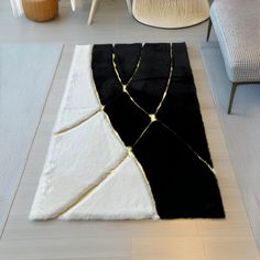 a black and white rug on the floor in a living room