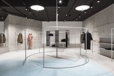 an empty clothing store with clothes on display