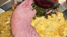 the ham is on top of scrambled eggs and spinach with red onion wedges