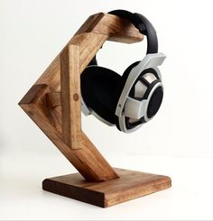 a pair of headphones sitting on top of a wooden stand