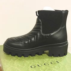 Brand New In Box. 100% Authentic Gucci Lifford Matelasse Boots Color- Black Style 643958 Dh7d0 1000 Size 38 - Us 8 Features- Chevron Quilted Black Calkskin Leather With Embroidered Gg Logo On The Side Of The Boot. They Have A Round Toe For Comfort And Long Wearability. Easy On And Off And The Boot Features Stretchable Sides. 2” Rubber Heel With 1.25” Platform. They Come Exactly As Shown In Photos. Original Box, Dust Bags And Paperwork. Designer Gucci Boots For Work, Gucci Leather Boots For Winter, Gucci Round Toe Boots For Workwear, Elegant Gucci Boots For Winter, Gucci Boots For Workwear, Chic Black Gucci Boots, Gucci Winter Boots With Round Toe, Gucci Black Winter Boots, Designer Black Gucci Boots