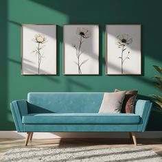 a living room with green walls and two paintings on the wall