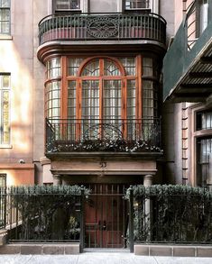 an apartment building with iron balconies and windows