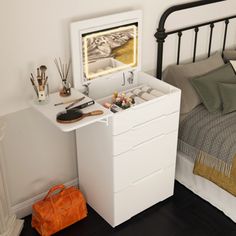 a bedroom with a bed, nightstand and small chest of drawers on the floor next to it