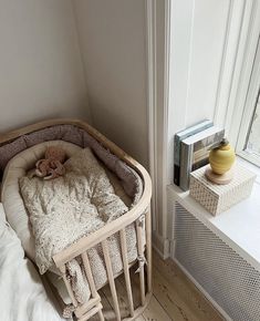 a baby crib with a teddy bear in it