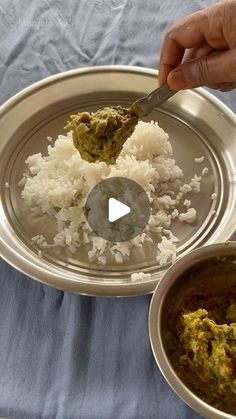 a person is spooning food out of a bowl on a plate with rice and broccoli