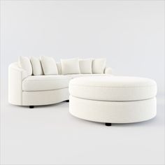 a white couch and ottoman sitting next to each other