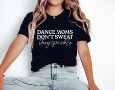 Get ready to rock the dance floor in style with our cute Dance Mom Shirt! Whether you're supporting your little dancer at a competition or just showing off your love for dance, this cute and trendy tee is perfect for any proud dance mom.  H O W - T O - O R D E R  - Be sure to review the size chart in the photos before making your selection. - Select the size and color you want from the drop-down menus. - Click the "Add to Cart" button, then proceed to check out once you have added all of your items. M A T E R I A L S Solid Colors are 100% Ring-Spun Cotton, Heather Colors are a Cotton Poly Blend. S H I R T - S I Z I N G Please use the Size Chart included in the listing photos to determine which size you need. Measure the length and width of your favorite T- shirt and compare these measureme Fitted Hip Hop T-shirt For Dance, Fitted Hip Hop Dance Tops, Fitted Hip Hop Dance T-shirt, Fitted Letter Print T-shirt For Dance Class, Black Graphic Print Top For Dance Class, Black Top With Graphic Print For Dance Class, Black Summer Top For Dance Class, Black Tops With Letter Print For Dance Class, Black Relaxed Fit Top For Dance Class