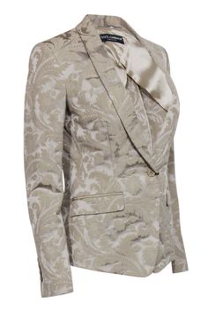 Elevate your style with Dolce & Gabbana's beige brocade blazer. Its single button and vintage flare add a touch of elegance to any outfit, whether you're dressing up for the office or keeping it casual with jeans and boots. Size 4 (IT 40) Made in Italy Shell 60% Cotton, 40% Polyester Lining 63% Polyester, 37% Cupro Single button closure Two front flap pockets Bust 34" Waist 31" Shoulder to hem 24.5" Shoulder to shoulder 15.5" Sleeve length 24" Fitted Jacquard Blazer For Spring, Spring Elegant Jacquard Blazer, Elegant Spring Jacquard Blazer, Elegant Jacquard Blazer For Spring, Elegant Single Breasted Jacquard Blazer, Single Breasted Jacquard Elegant Blazer, Elegant Single-breasted Jacquard Blazer, Elegant Jacquard Blazer For Party, Elegant Jacquard Party Suits