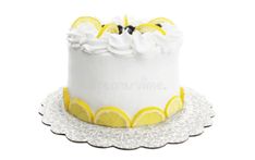 a white cake with lemon slices and icing