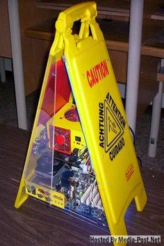 a yellow caution sign sitting on top of a wooden table